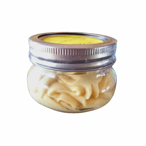Jar of yellow cream body butter inside a clear jar